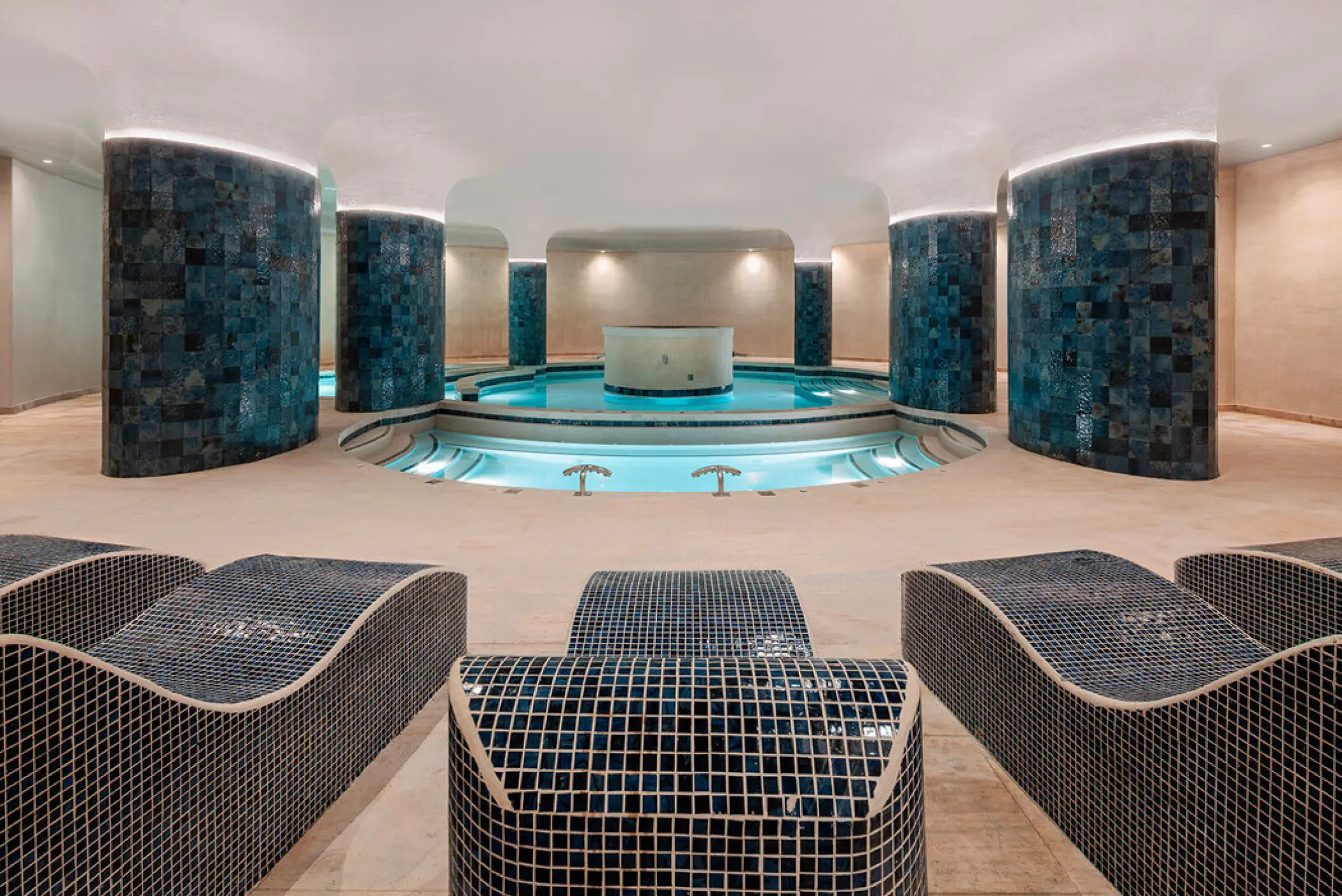 Hydrotherapy circuit with tiled loungers and pools at AVA Resort Cancun, Cancun