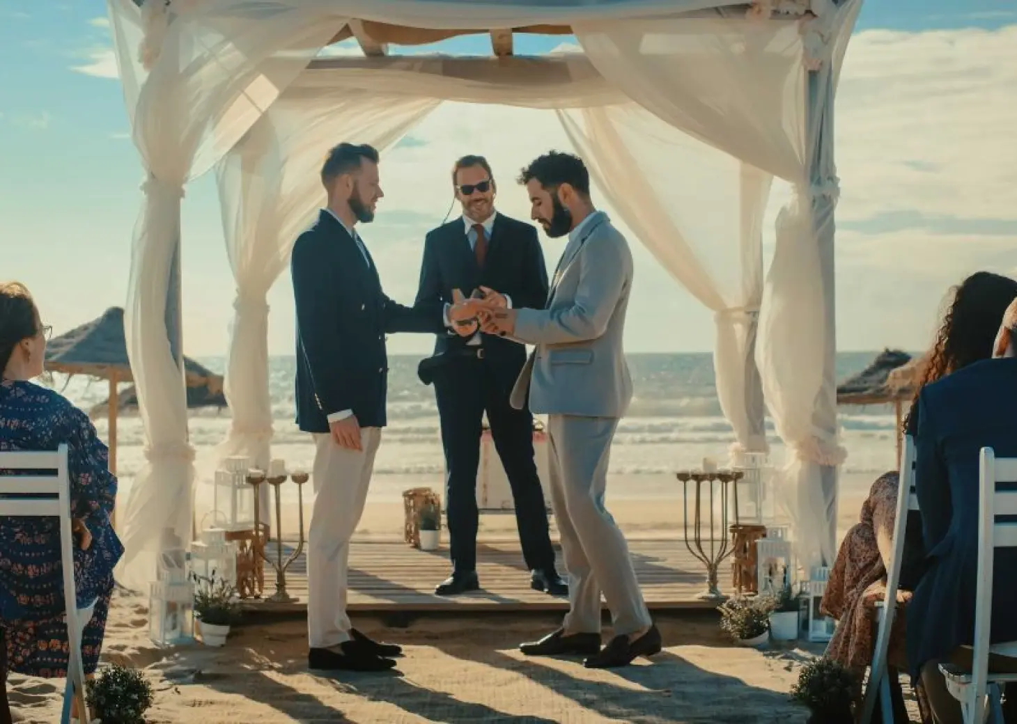 2 grooms, the officiant and guests at bahia principe grand coba