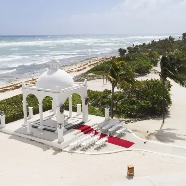 White beachfront wedding gazebo with a red aisle runner at Bahia Principe Grand Coba, Tulum