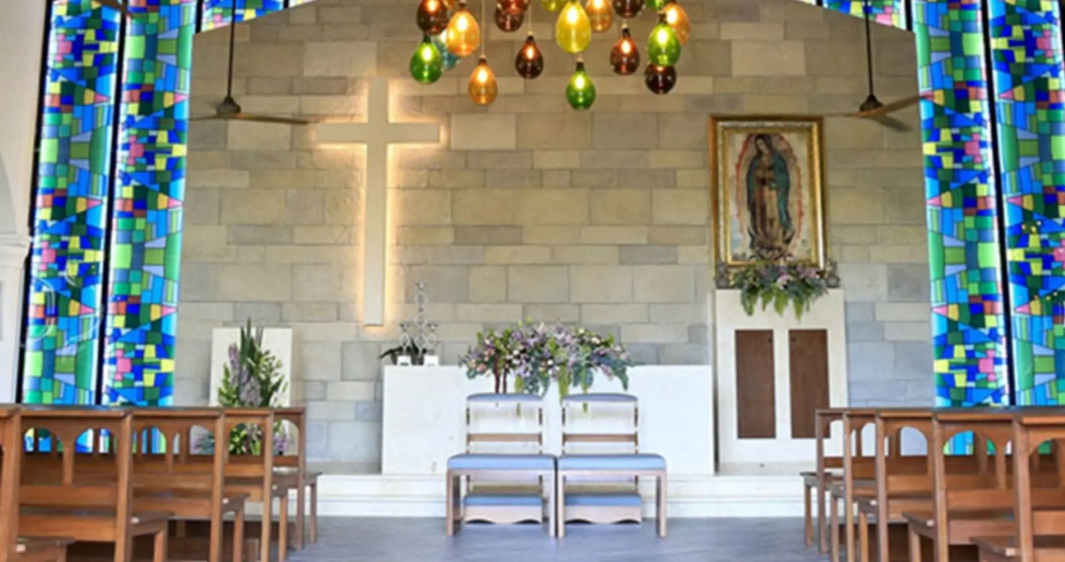 Chapel wedding ceremony altar with stained glass and stone walls at Bahia Principe Luxury Sian Ka’an, Tulum