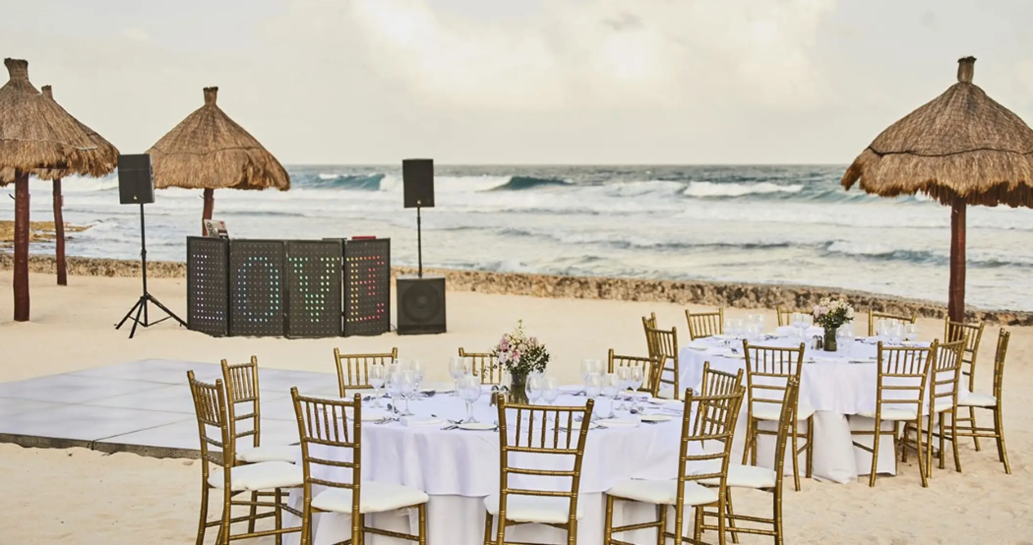 Beachfront wedding reception with DJ booth and dance floor at Bahia Principe Sian Ka’an, Tulum