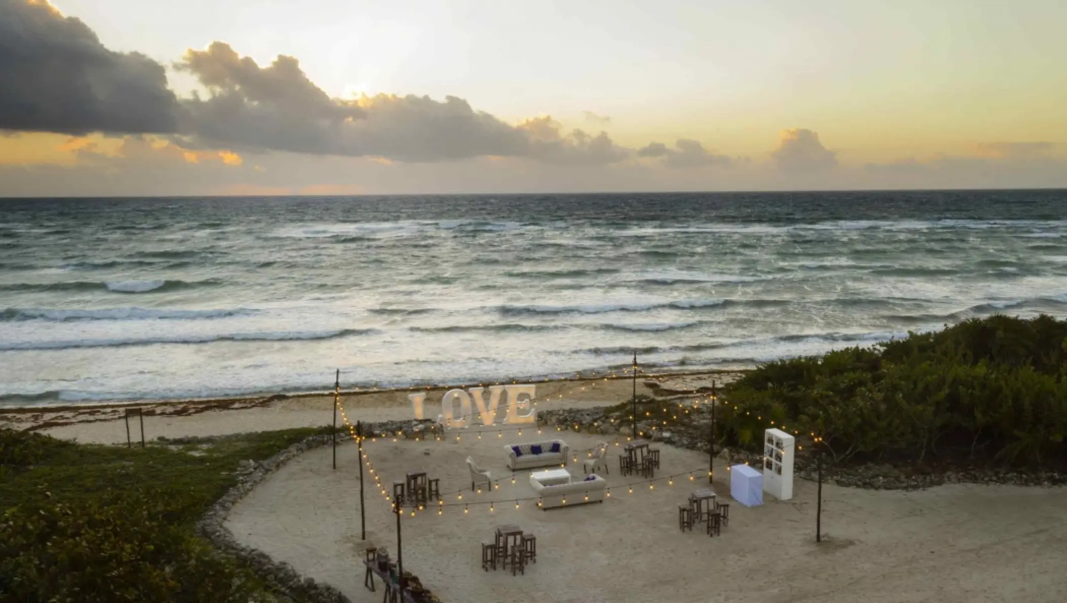 Beachfront wedding reception setup with LOVE marquee letters at Bahia Principe Luxury Sian Ka’an, Tulum