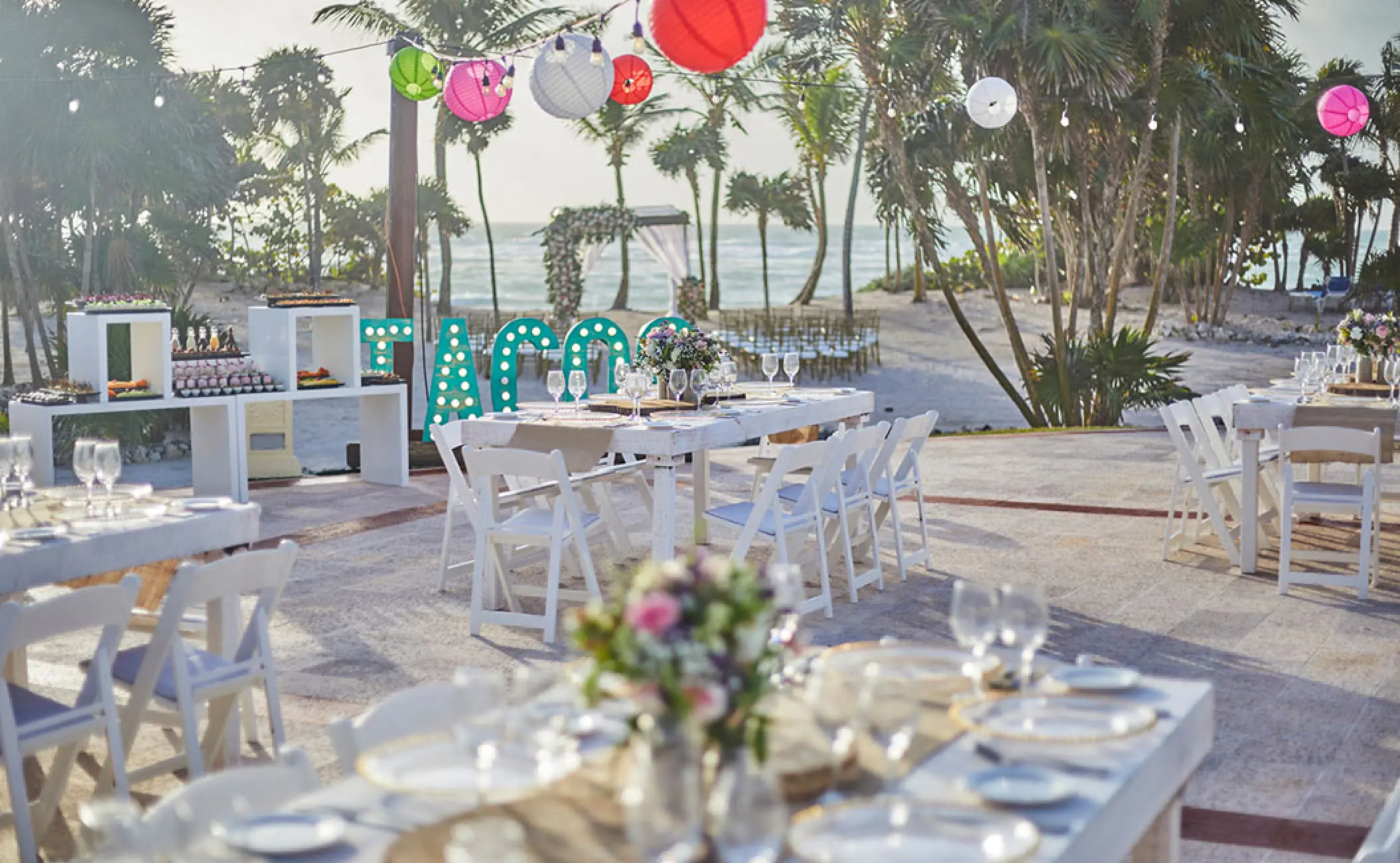 Poolside wedding reception with taco bar and paper lanterns at Bahia Principe Akumal, Tulum