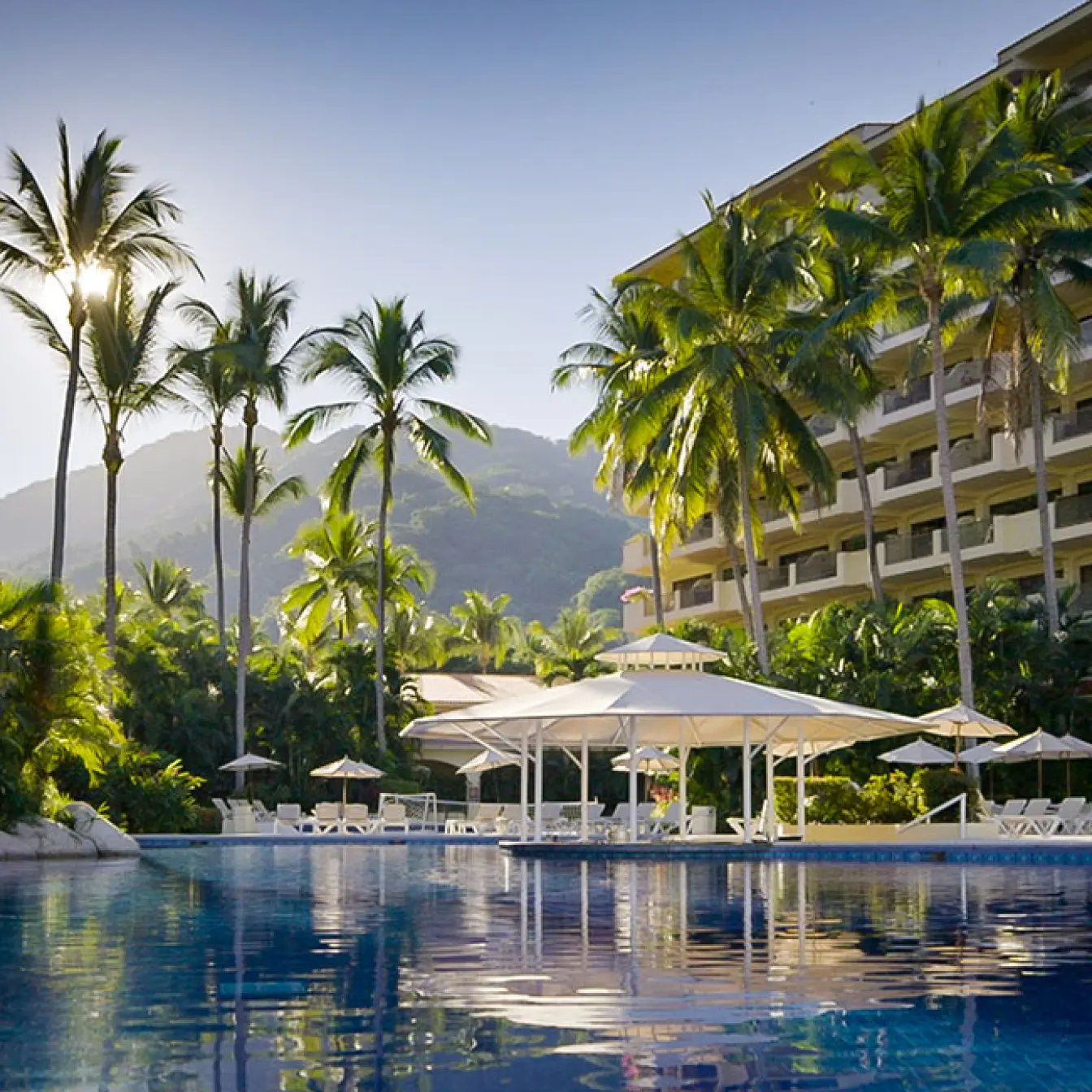Barcelo Puerto Vallarta swimming pools and guest buildings surrounded by palm trees, Puerto Vallarta