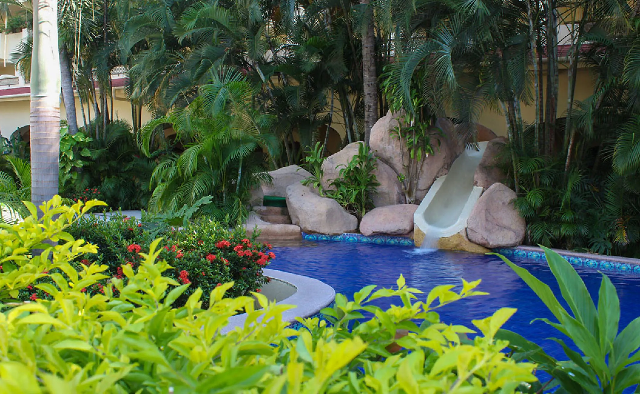 Barcelo Puerto Vallarta kid's pool slide surrounded by tropical gardens and rock formations, Puerto Vallarta