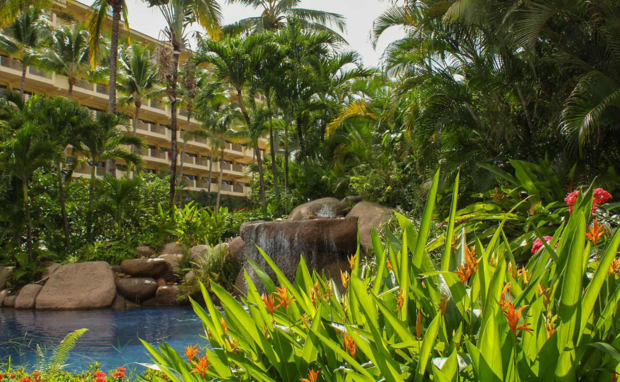 Tropical gardens and rock waterfall by the pool at Barcelo Puerto Vallarta