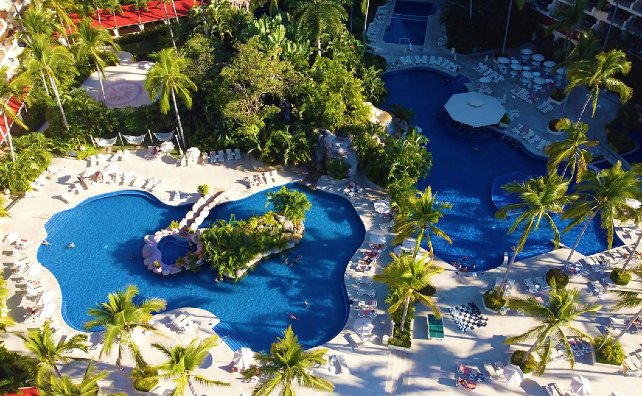 Aerial view of the pools and palm trees at Barcelo Puerto Vallarta