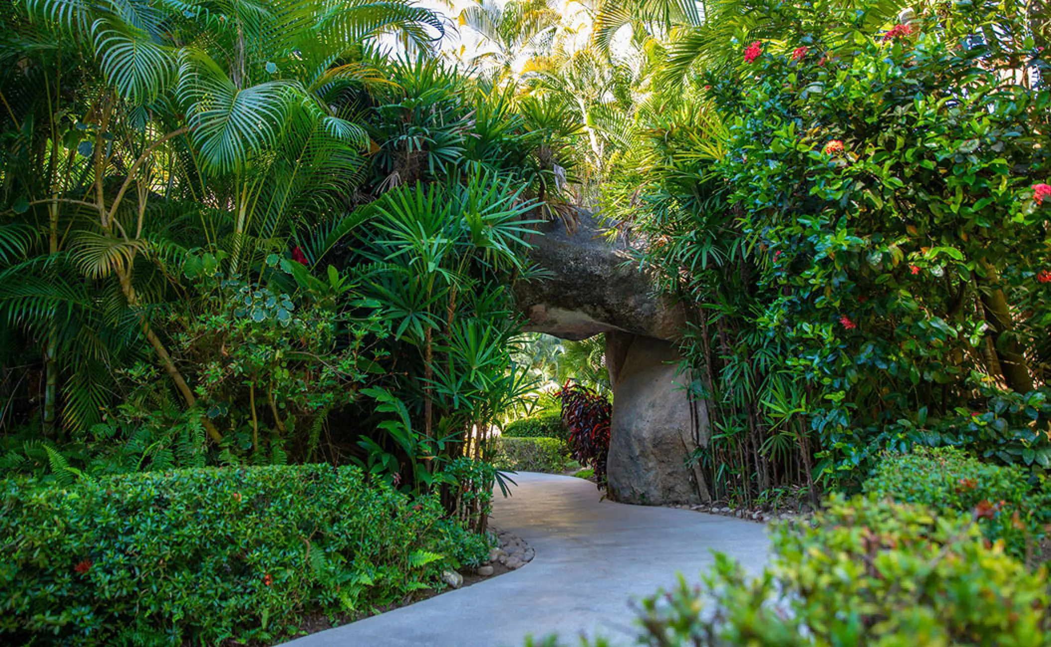 Barcelo Puerto Vallarta garden pathway under a stone archway, Puerto Vallarta