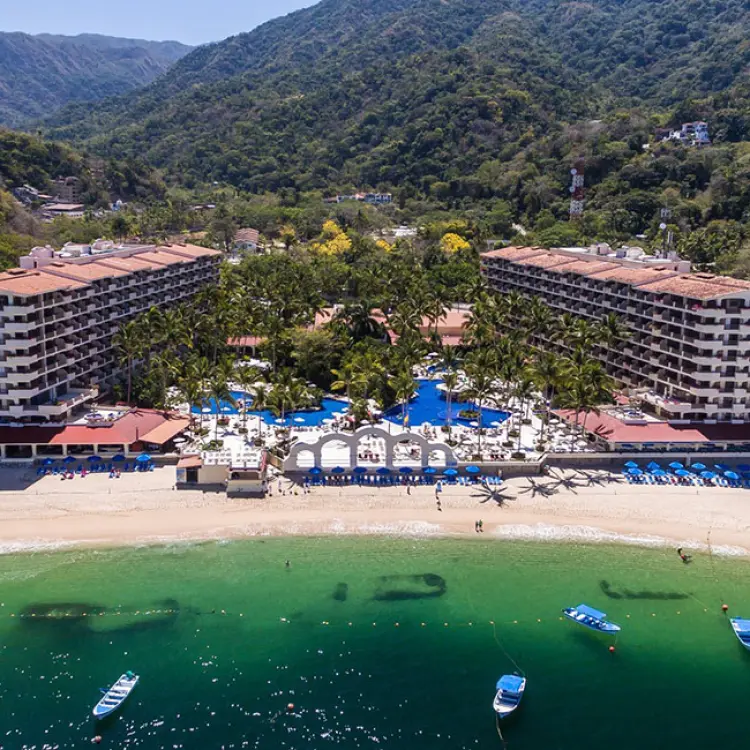 Aerial view of Barcelo Puerto Vallarta and its beach nestled against lush green mountains, Puerto Vallarta