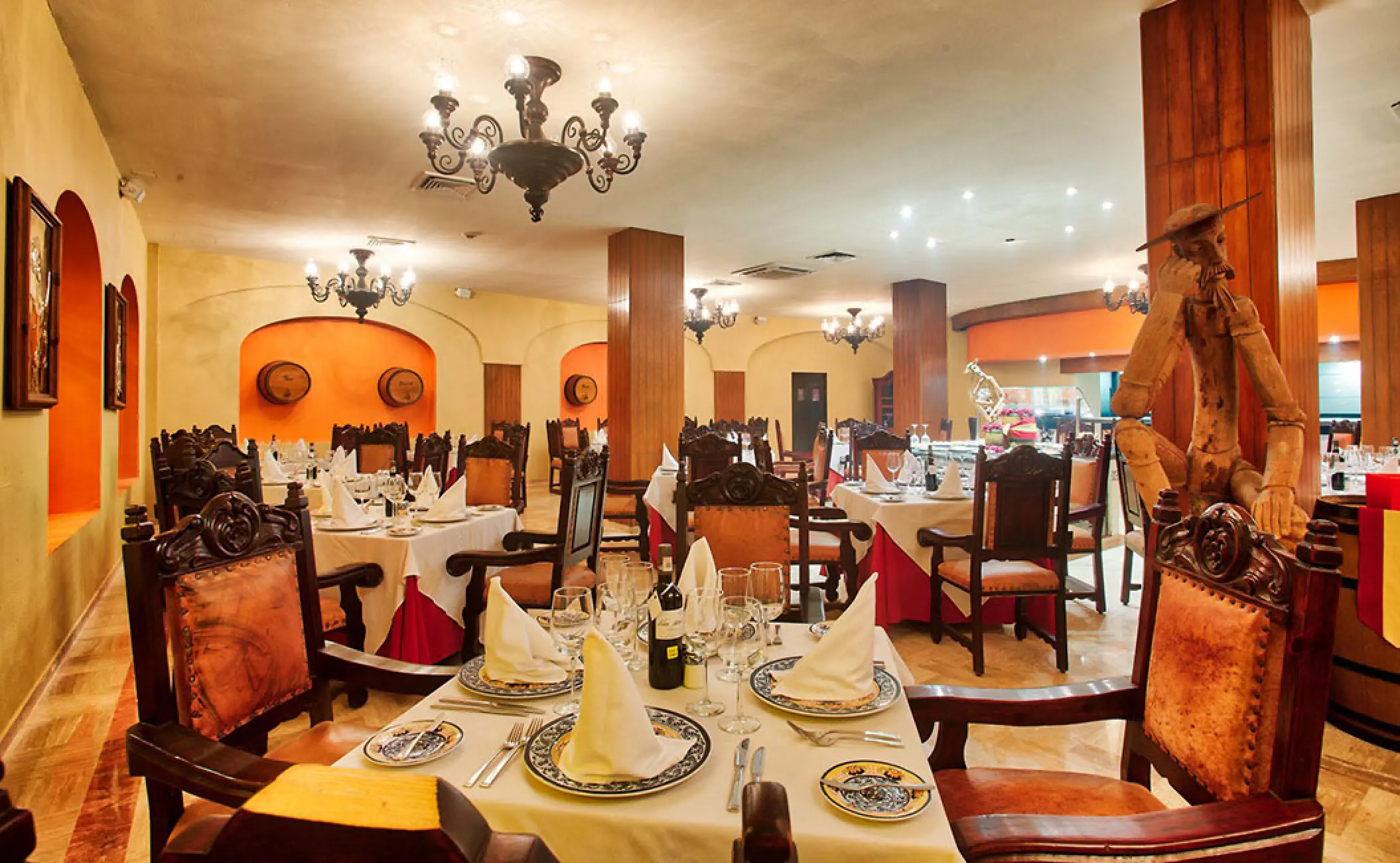 Don Quijote restaurant with wooden pillars and iron chandeliers at Barcelo Puerto Vallarta