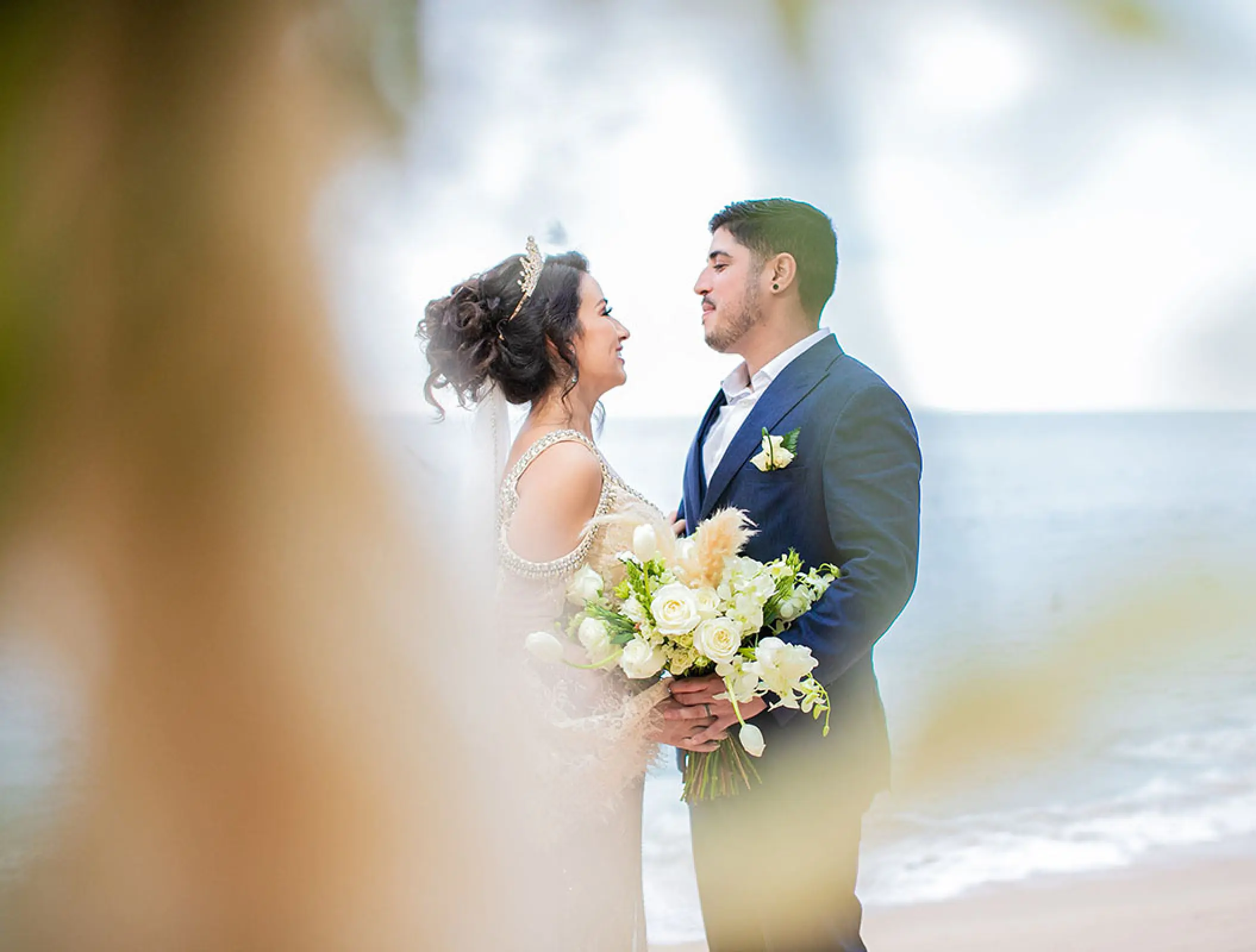 The bride and groom embracing on the beach at Barcelo Puerto Vallarta