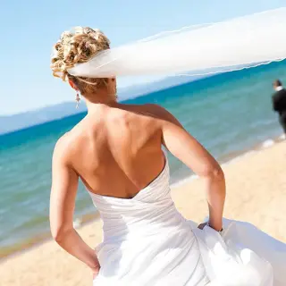 Bride's veil blowing in the wind during a beach wedding at Barcelo Puerto Vallarta