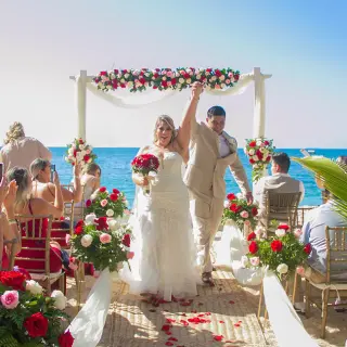 The couple celebrating after their beach ceremony at Barcelo Puerto Vallarta