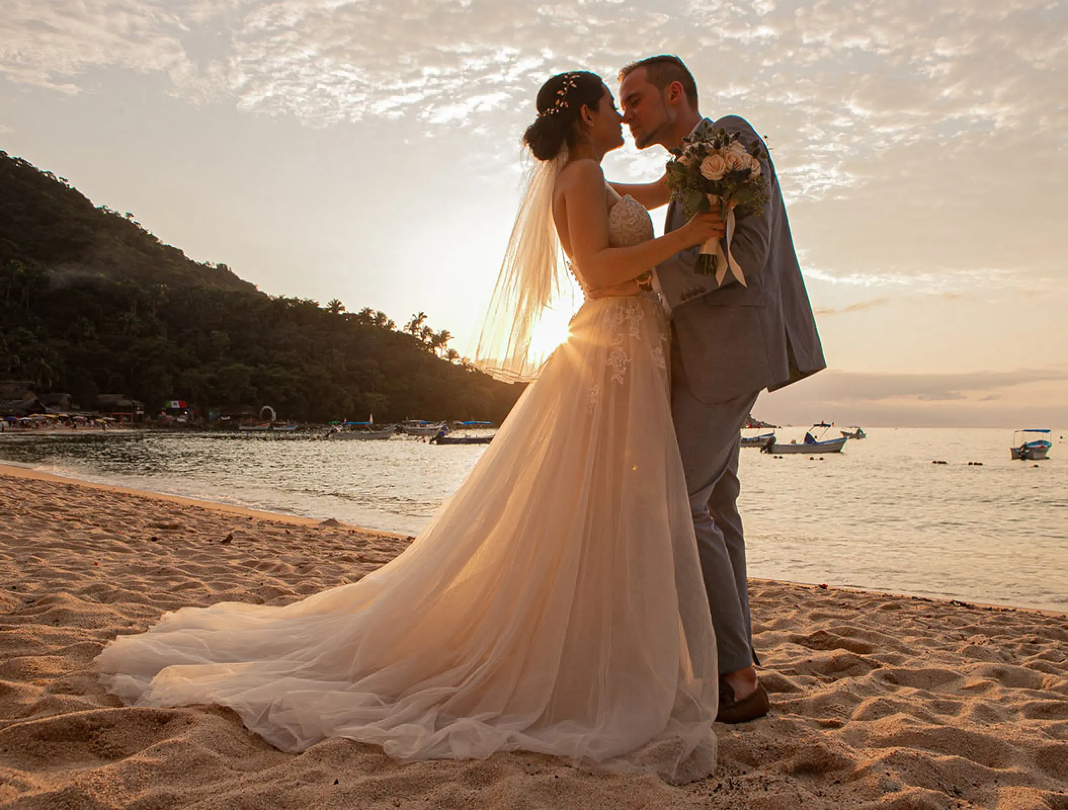Bride and groom sharing a sunset moment on the beach at Barcelo Puerto Vallarta