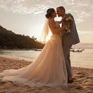 Bride and groom sharing a sunset moment on the beach at Barcelo Puerto Vallarta
