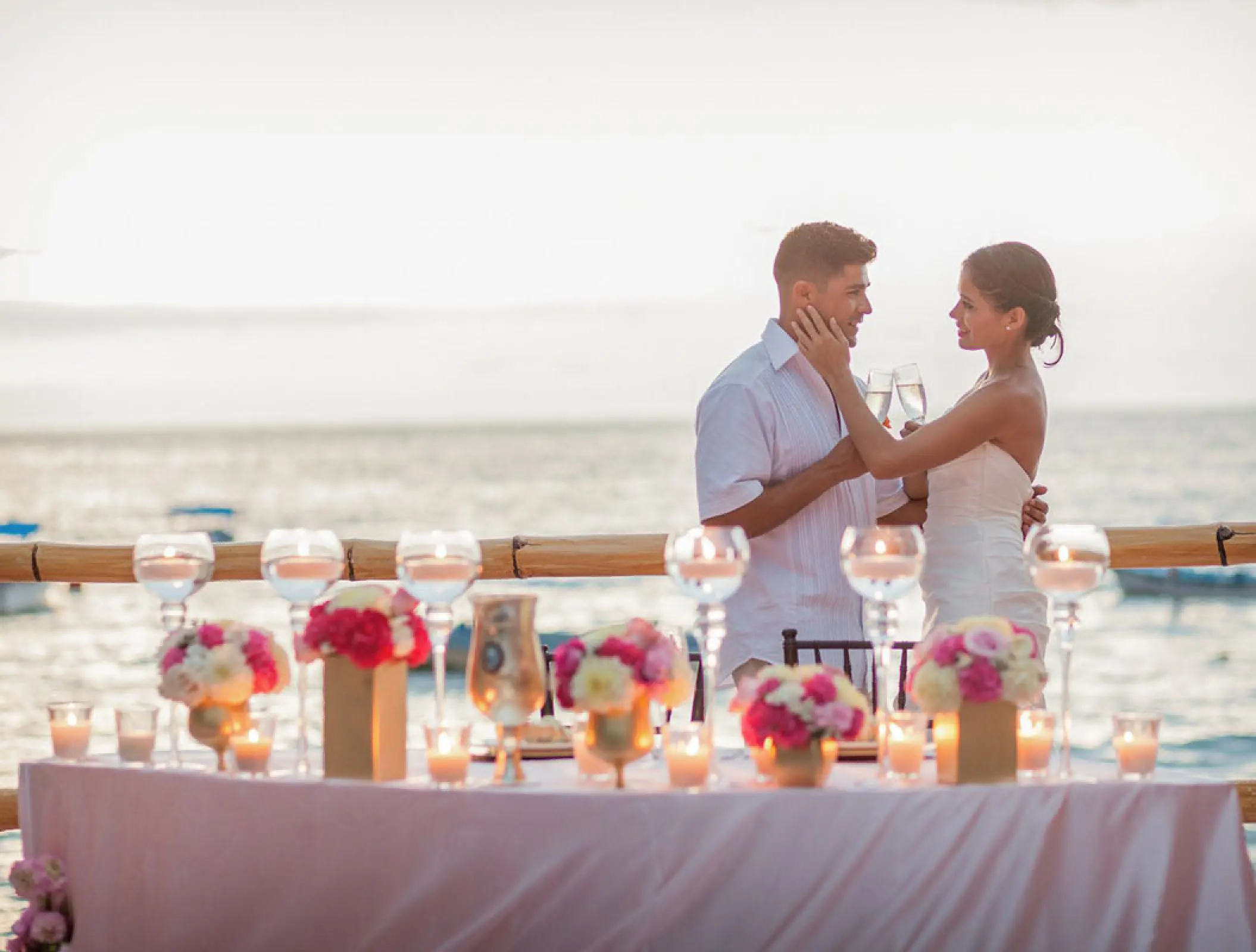 The bride and groom toast at an intimate wedding reception at Barcelo Puerto Vallarta