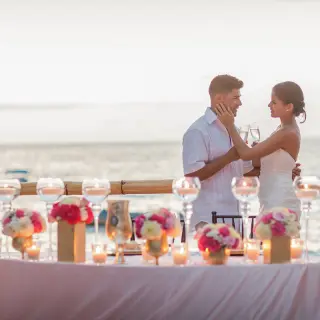 The bride and groom toast at an intimate wedding reception at Barcelo Puerto Vallarta