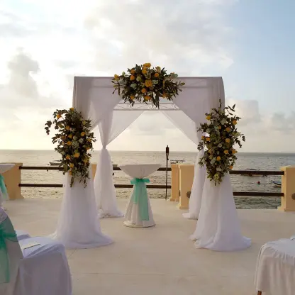 Oceanfront wedding ceremony gazebo with floral arrangements at Barcelo Puerto Vallarta