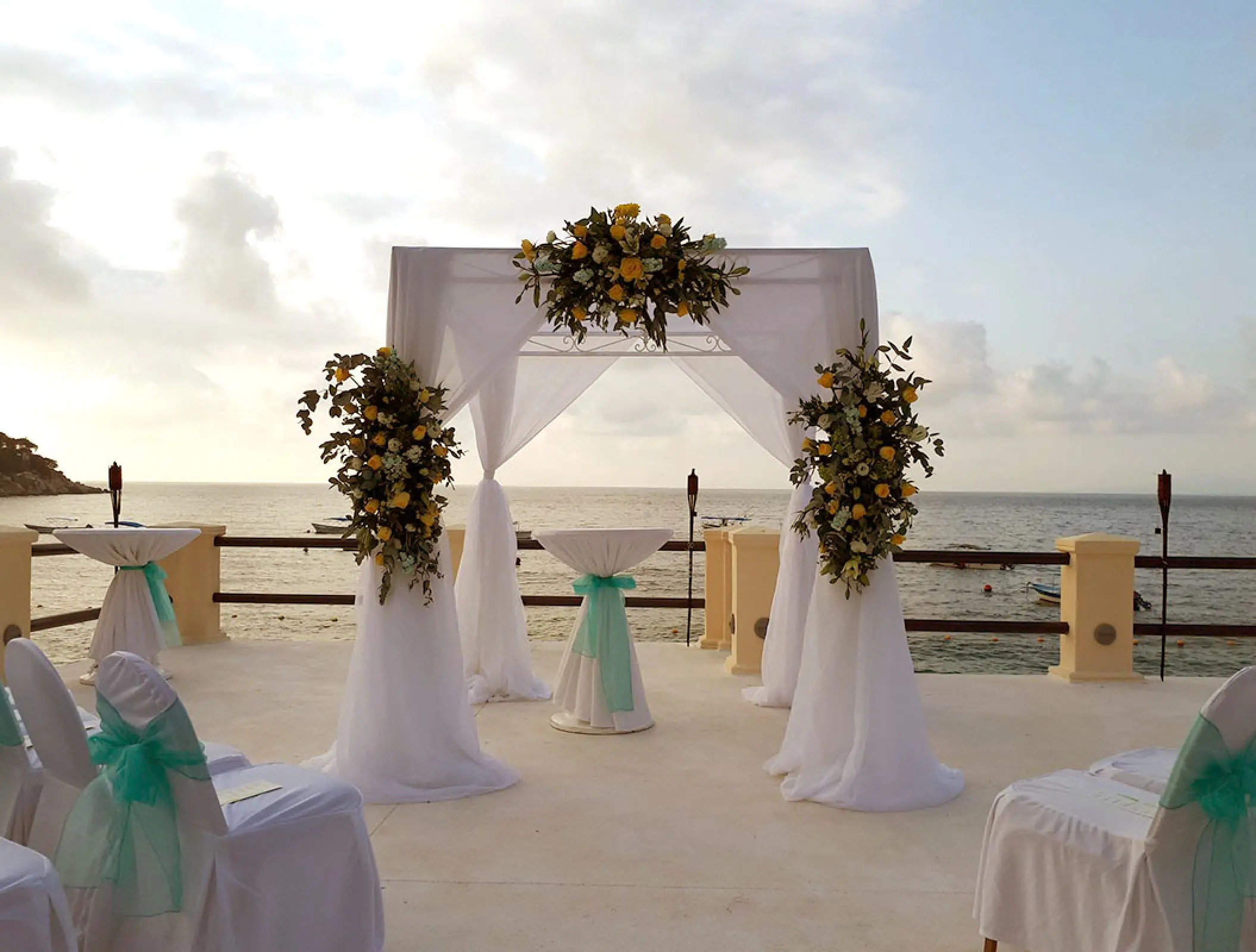 Oceanfront wedding ceremony gazebo with floral arrangements at Barcelo Puerto Vallarta