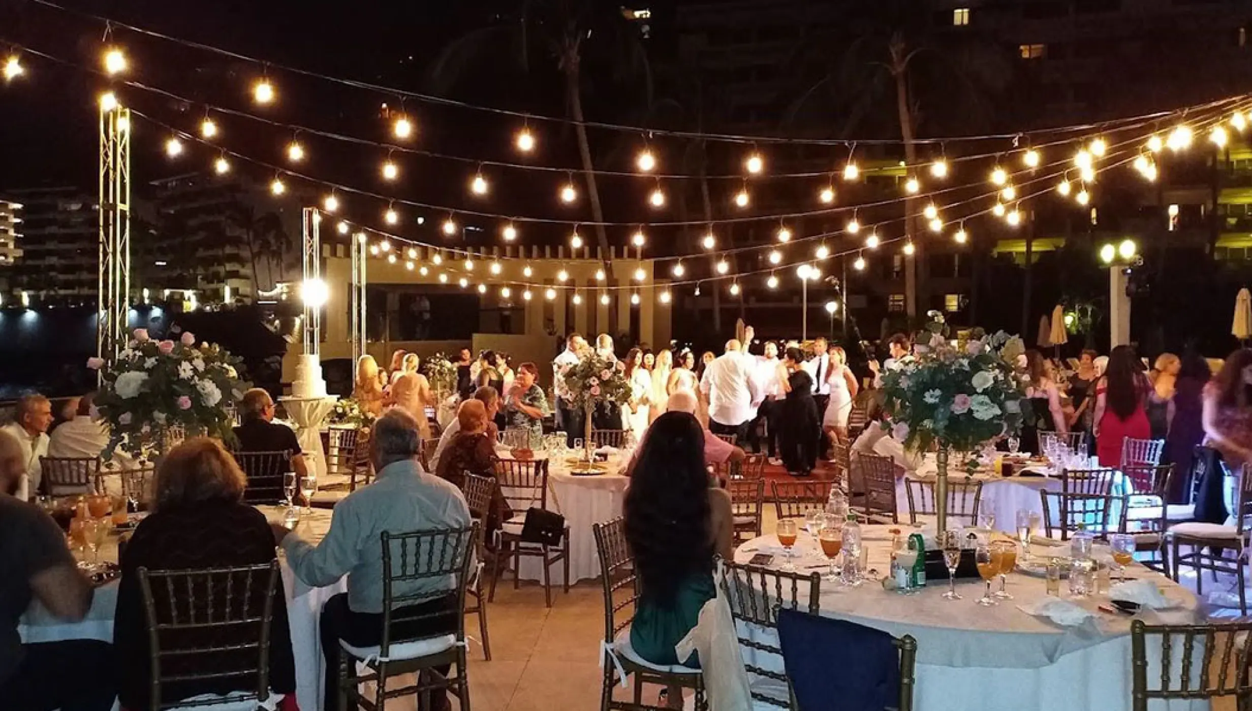 Outdoor wedding reception with string lights at night on the terrace at Barcelo Puerto Vallarta