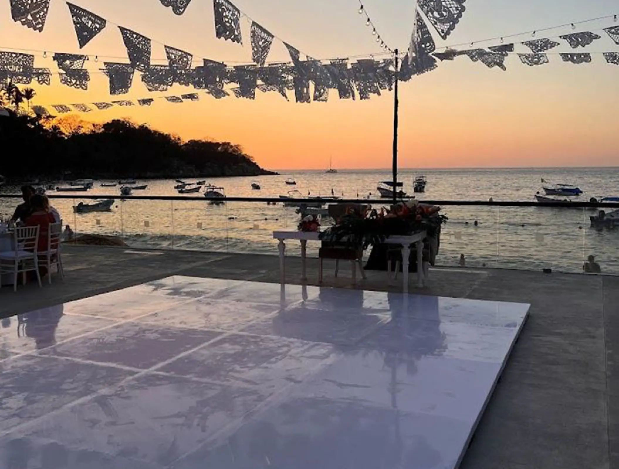 Terrace wedding reception setup with dance floor at sunset, Barcelo Puerto Vallarta