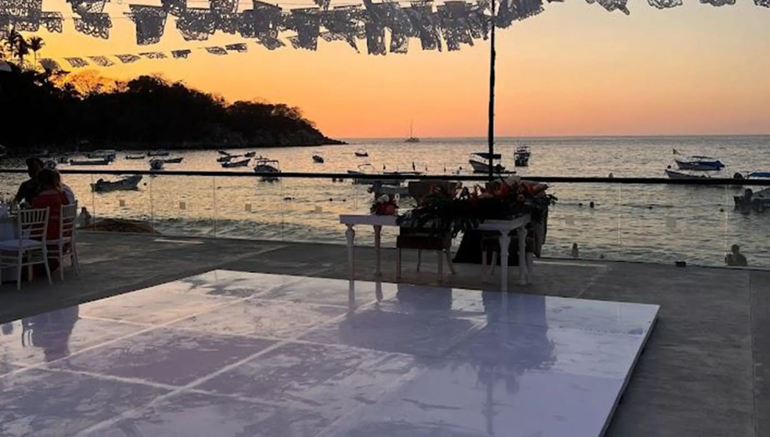 Terrace wedding reception setup with dance floor at sunset, Barcelo Puerto Vallarta
