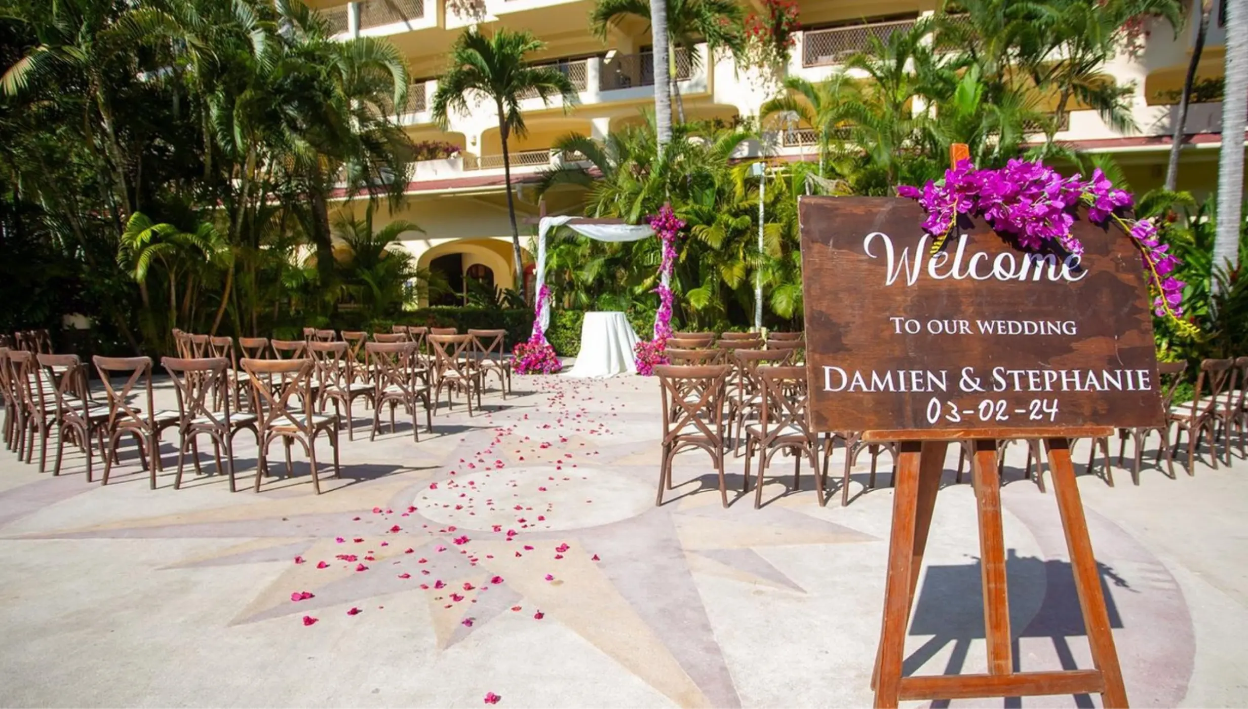 La Placita wedding ceremony setup with wooden welcome sign at Barcelo Puerto Vallarta