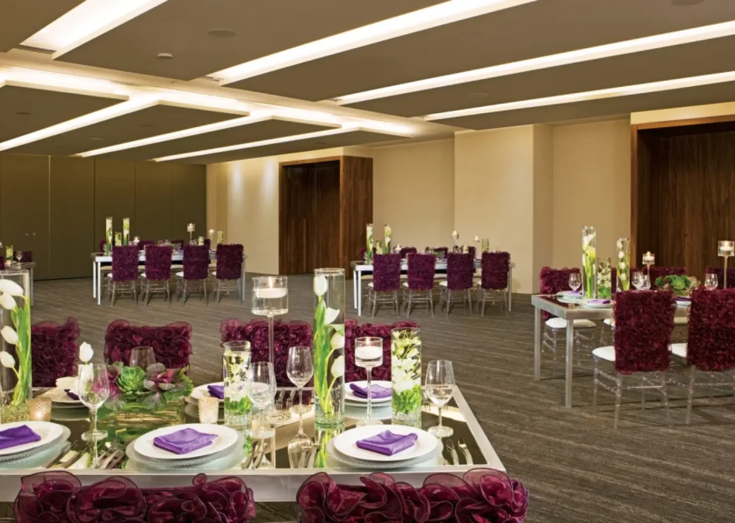 Indoor wedding reception setup with purple decor at Breathless Cabo San Lucas
