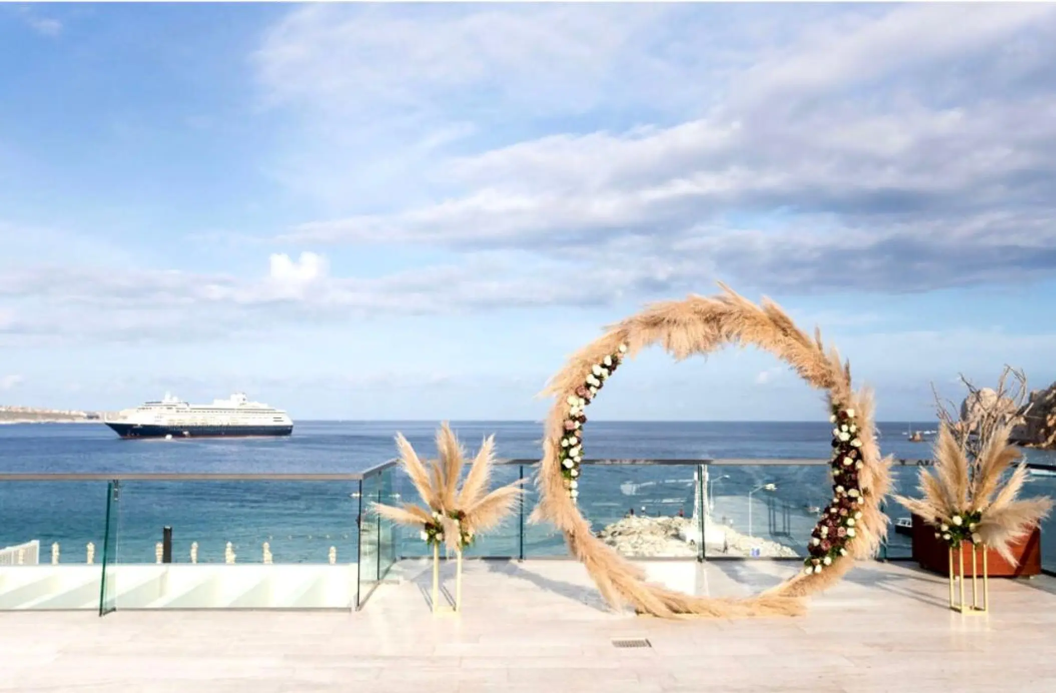 Rooftop wedding ceremony with a circular floral arch at Breathless Cabo San Lucas