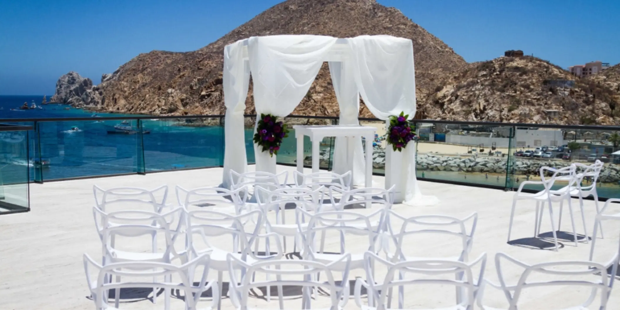 Terrace wedding ceremony at Breathless Cabo San Lucas with a white draped gazebo overlooking the ocean