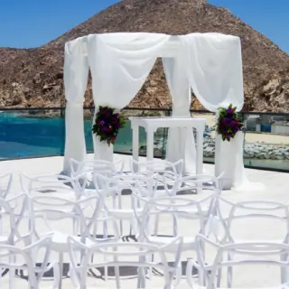 Terrace wedding ceremony at Breathless Cabo San Lucas with a white draped gazebo overlooking the ocean