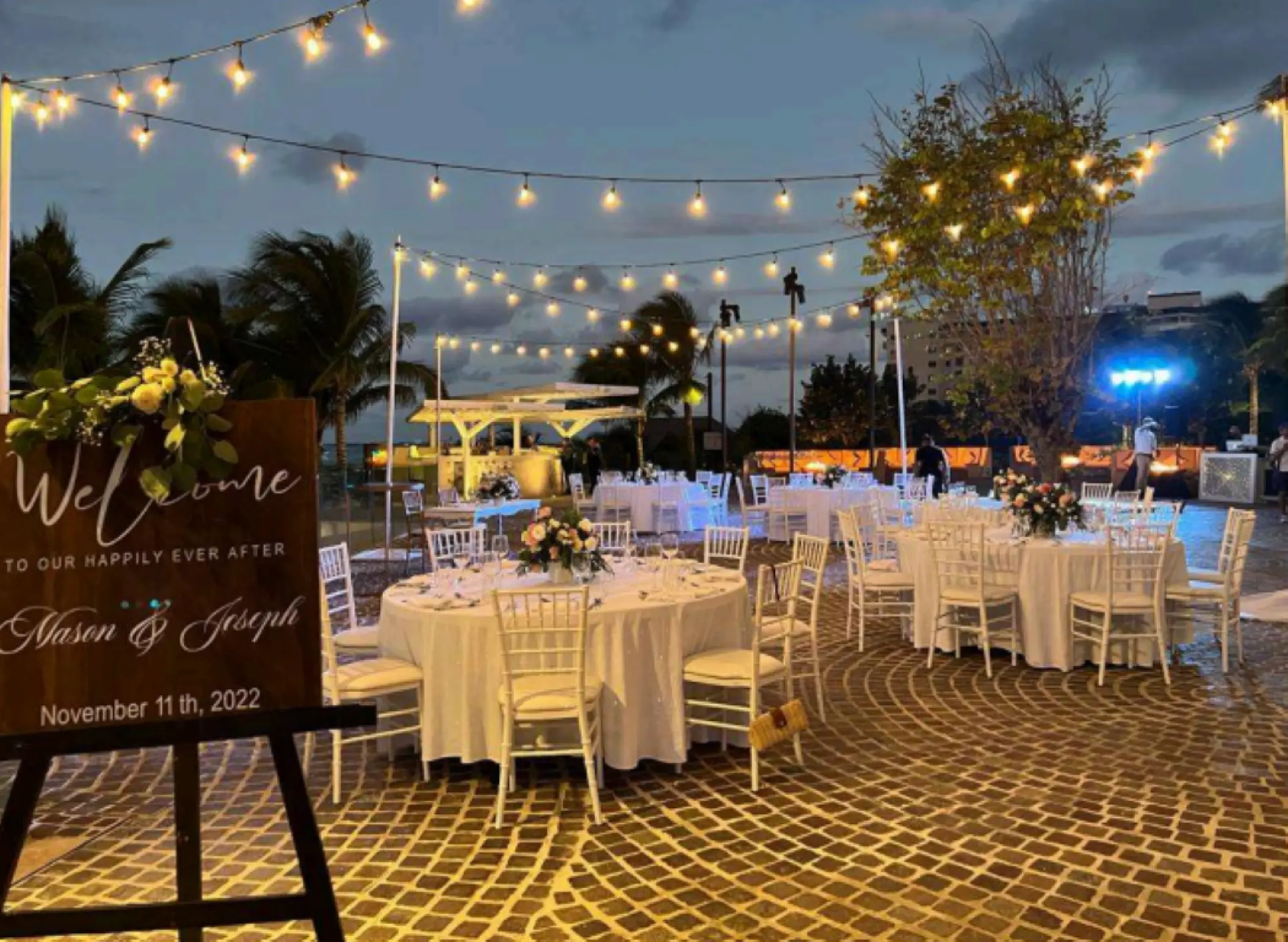 Outdoor wedding reception with string lights and white tables at Breathless Cancun Soul, Cancun