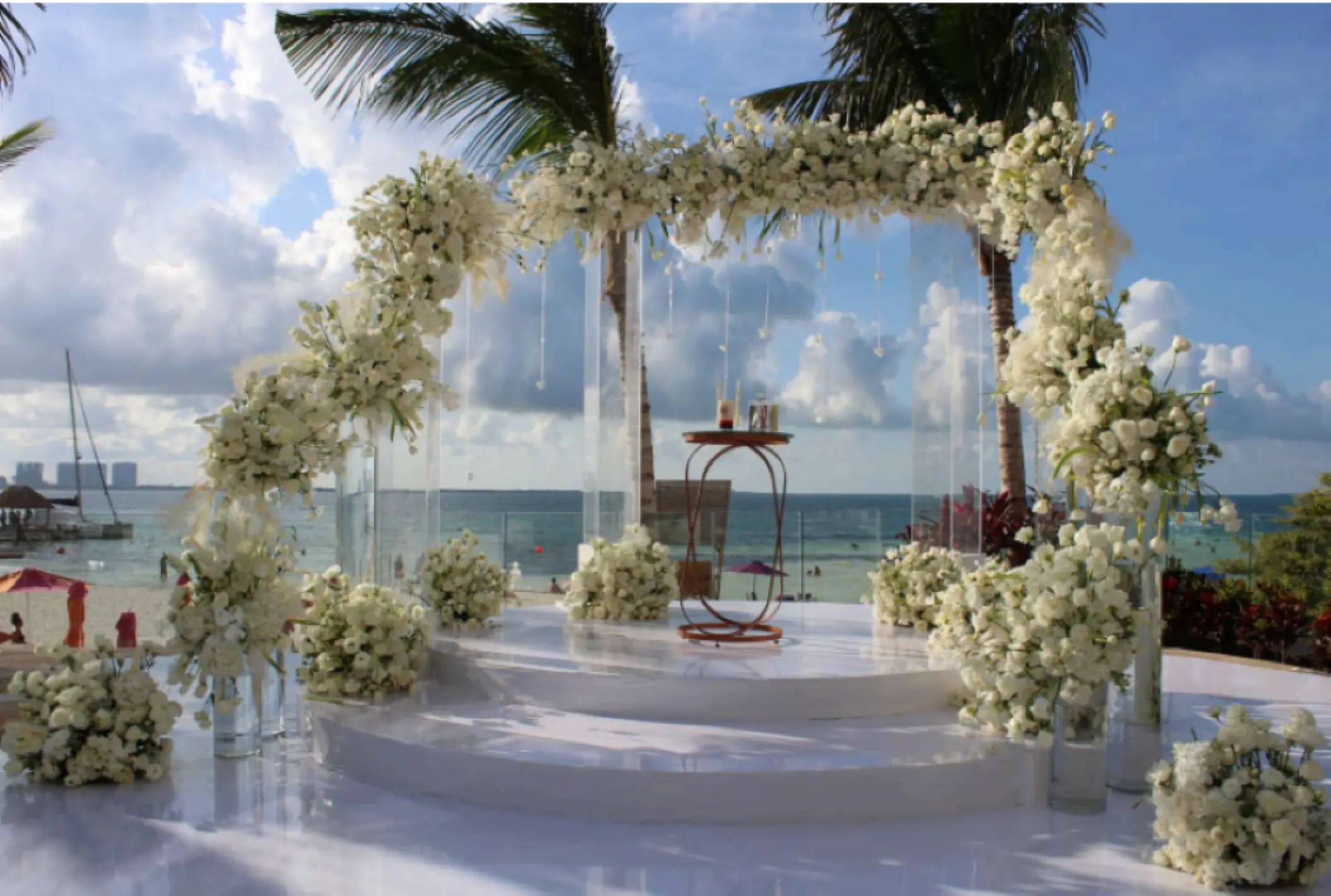 White floral arch at an oceanfront wedding ceremony venue, Breathless Cancun Soul