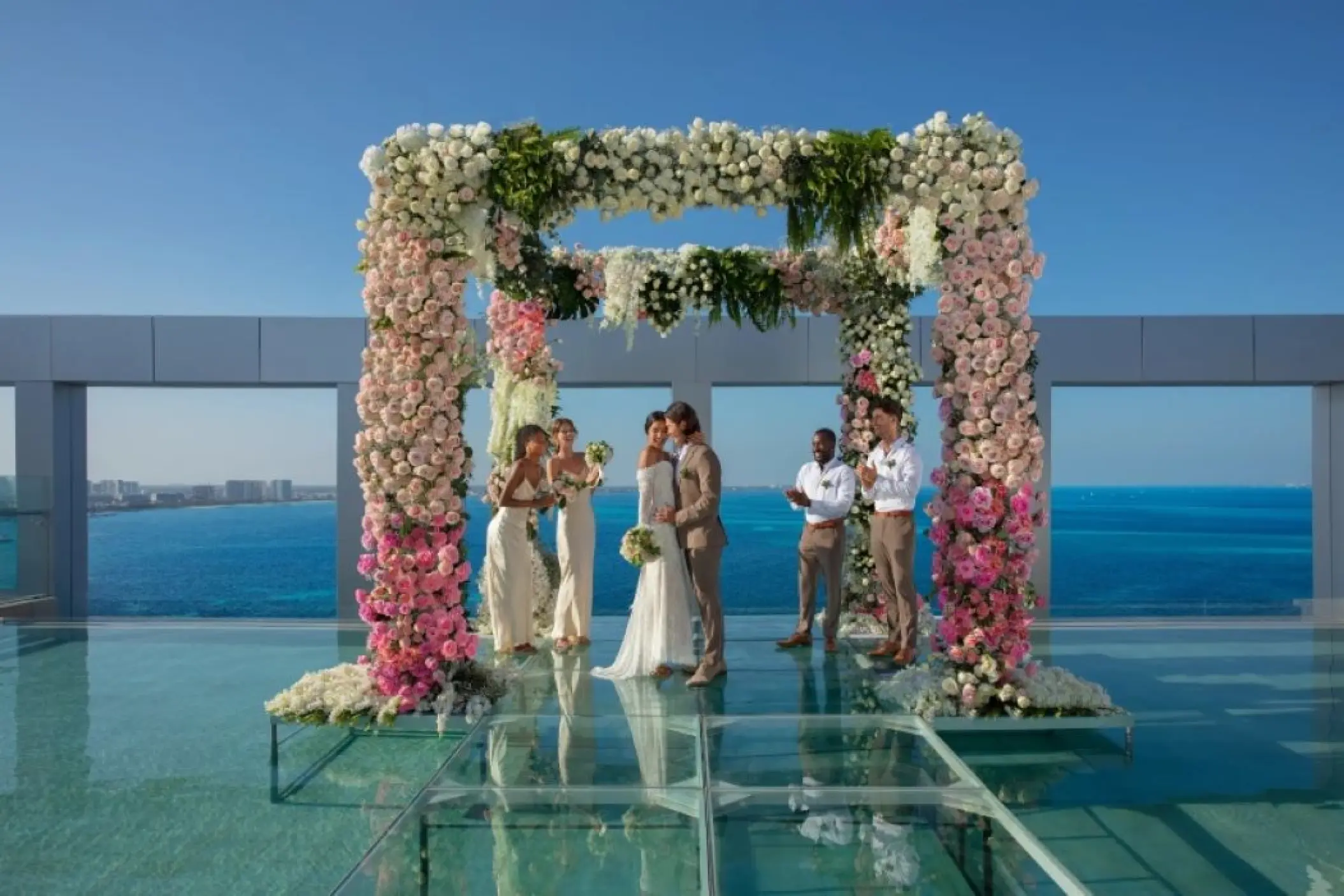 Rooftop wedding ceremony under a floral arch at Breathless Cancun Soul, Cancun