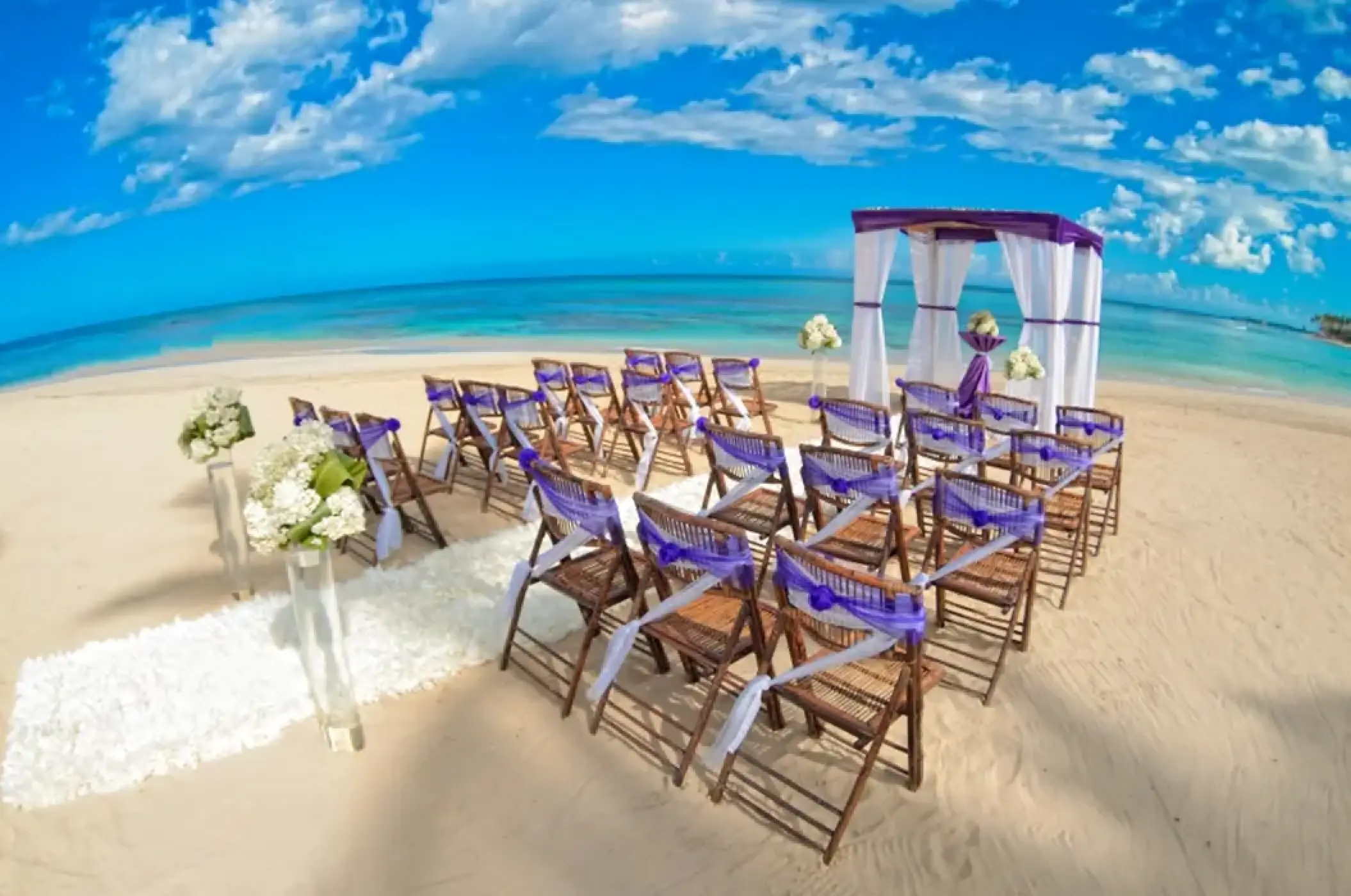 Beachfront wedding ceremony with purple accents at Breathless Punta Cana, Punta Cana