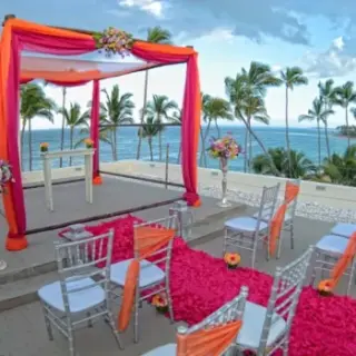 Rooftop wedding ceremony setup with orange and pink decor at Breathless Punta Cana, Punta Cana