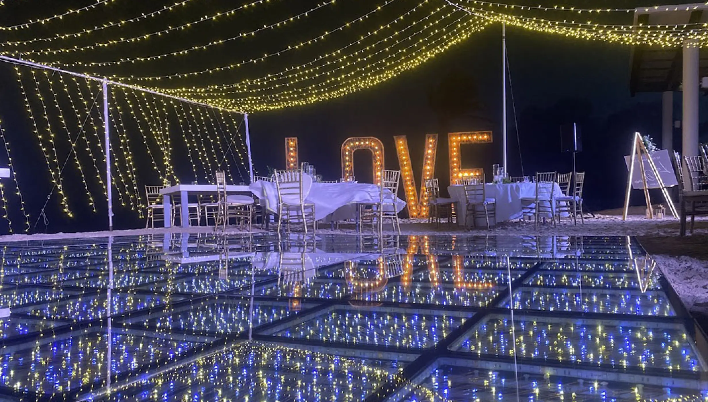 Night wedding reception with lit dance floor and marquee letters at Breathless Riviera Cancun, Riviera Maya