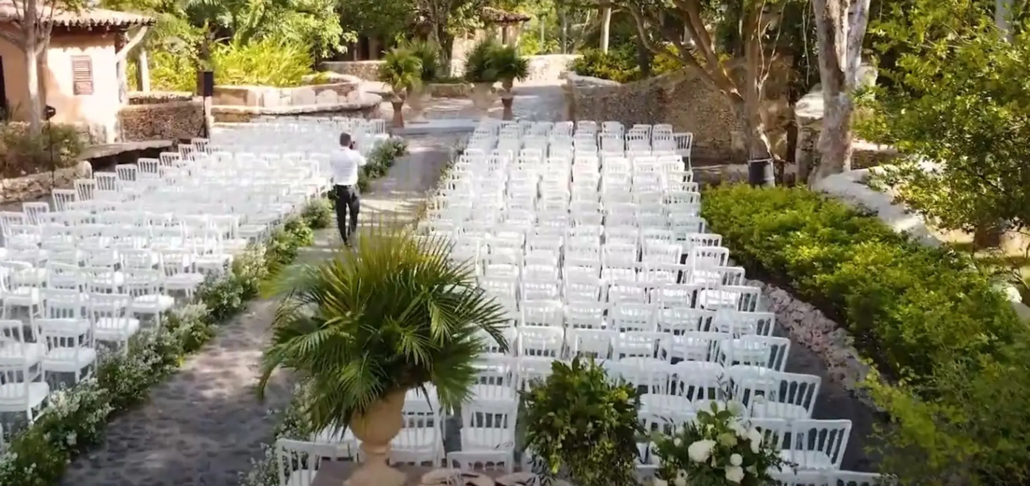 Garden wedding ceremony setup with rows of white chairs at Casa de Campo, La Romana