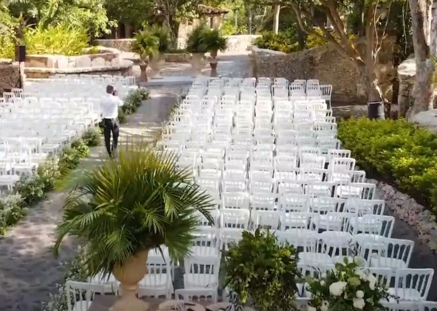 Garden wedding ceremony setup with rows of white chairs at Casa de Campo, La Romana