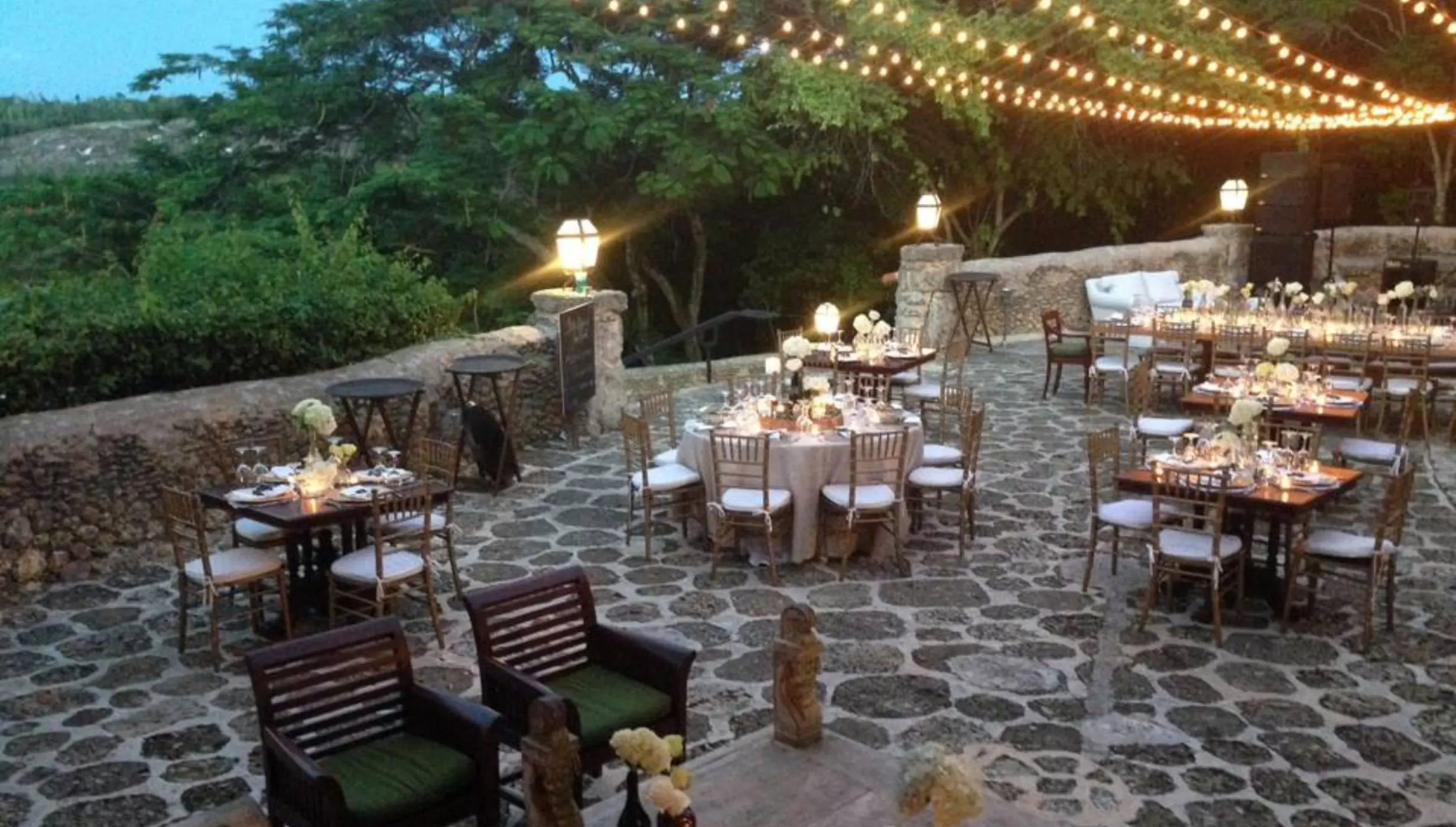 Stone terrace wedding reception with string lights at Casa de Campo, La Romana