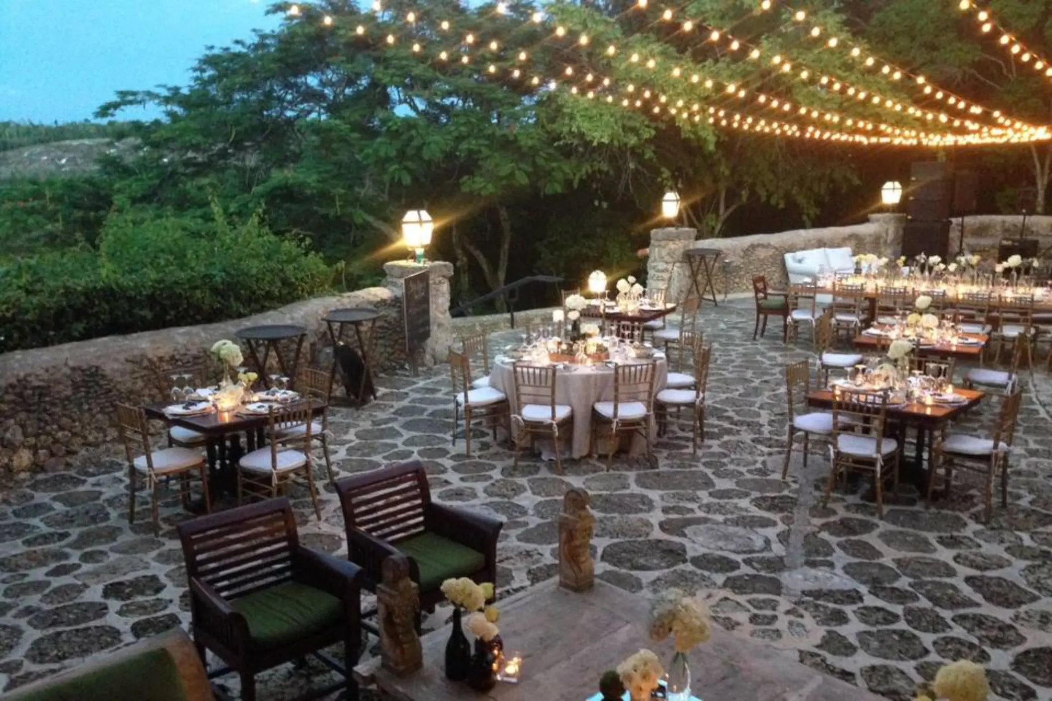 Stone terrace wedding reception with string lights at Casa de Campo, La Romana