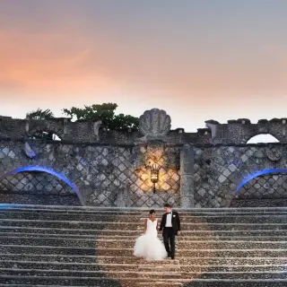 The bride and groom walking down the stone amphitheater steps at Casa de Campo, La Romana