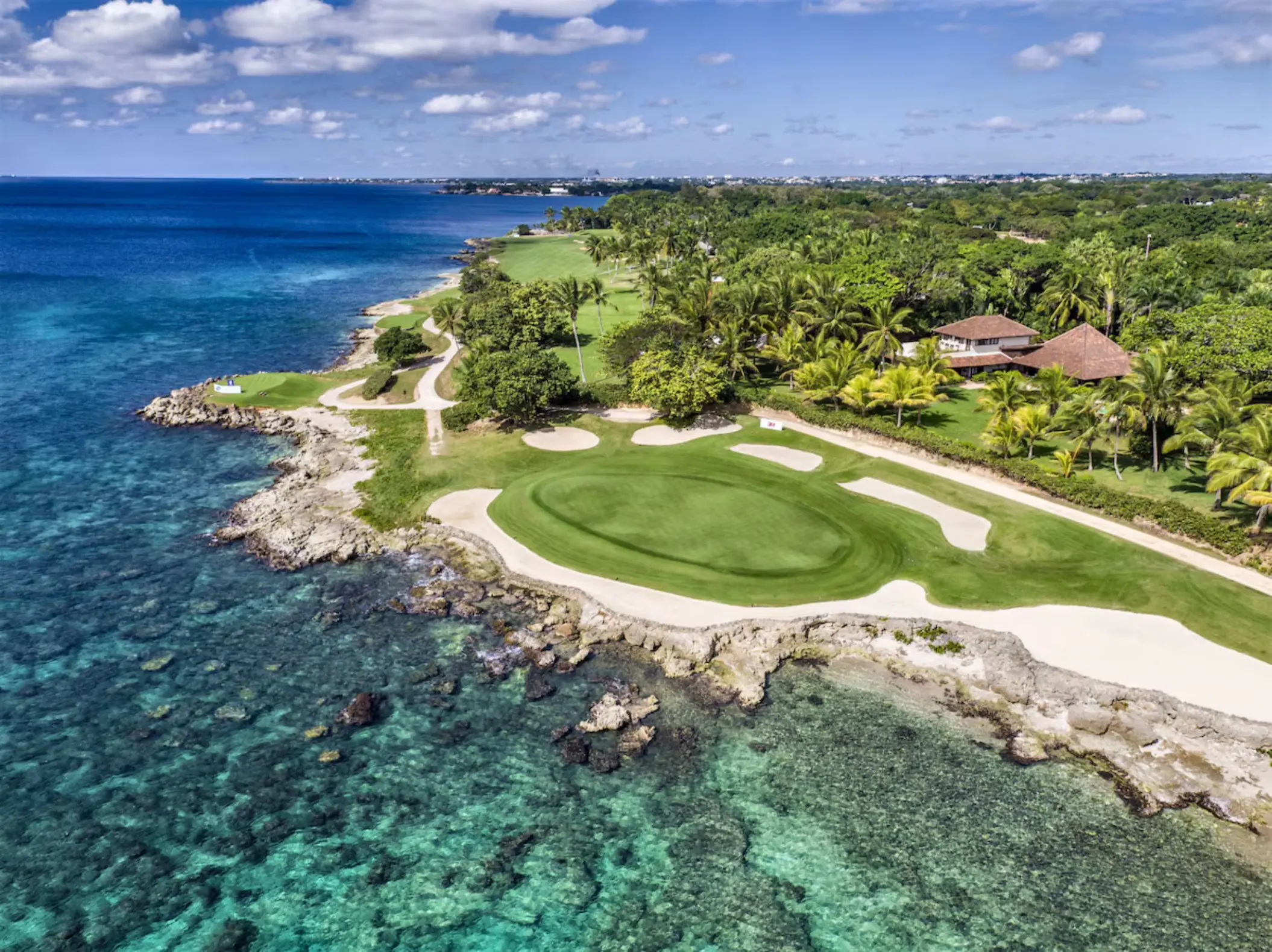 Casa de Campo oceanfront golf course green along the rocky coastline, La Romana