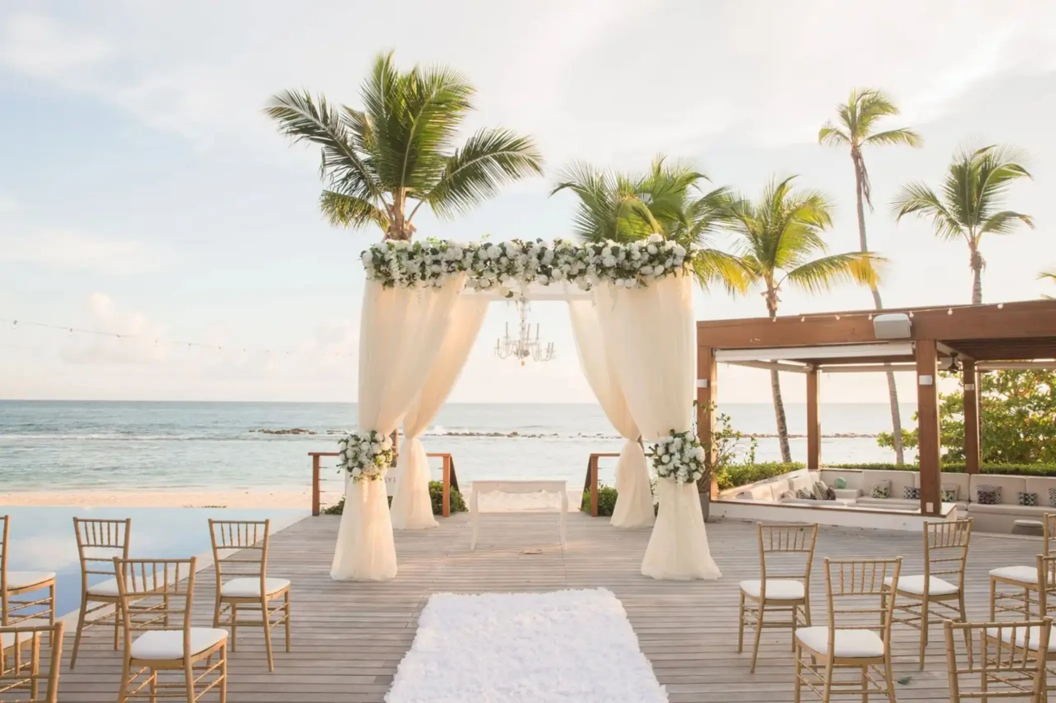 Beachfront wedding ceremony on a wooden deck at Casa de Campo, La Romana