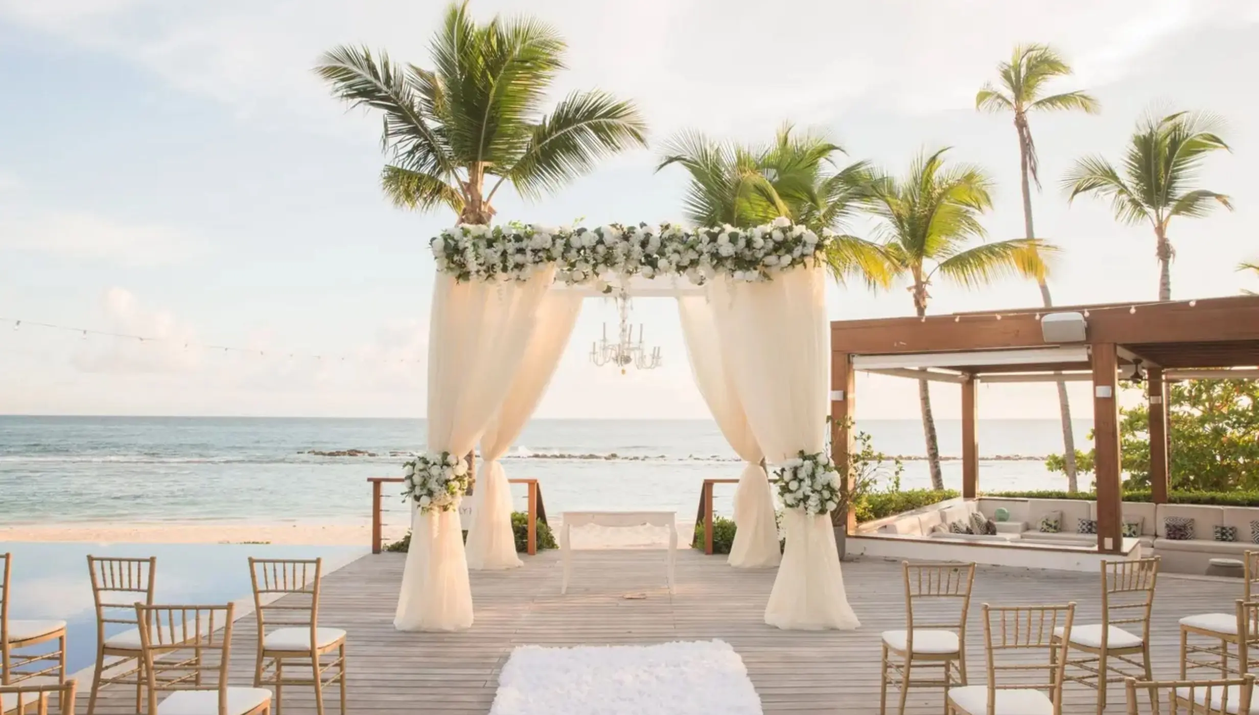 Beachfront wedding ceremony on a wooden deck at Casa de Campo, La Romana