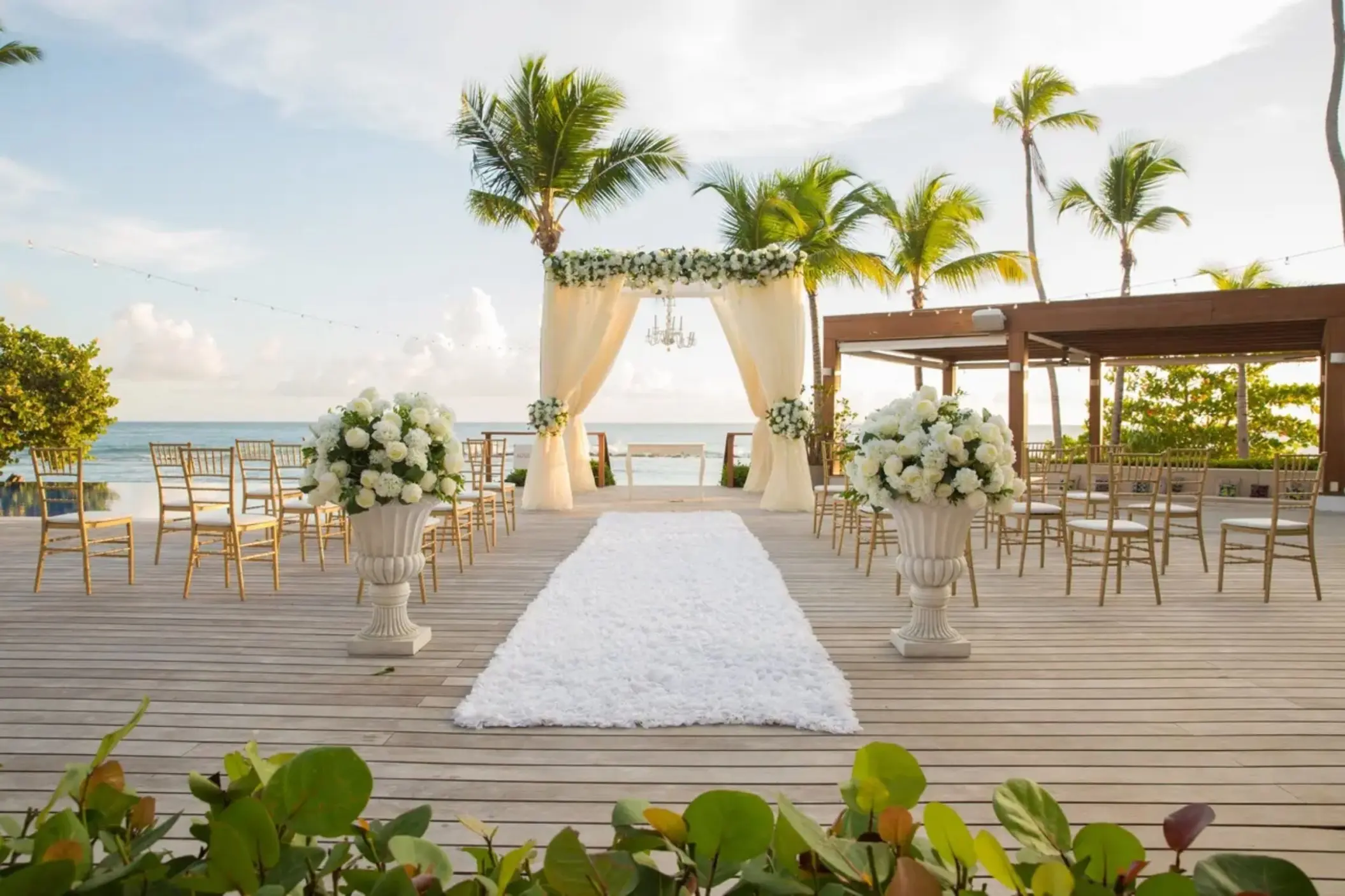 Beachfront wedding ceremony on a wooden deck at Casa de Campo, La Romana