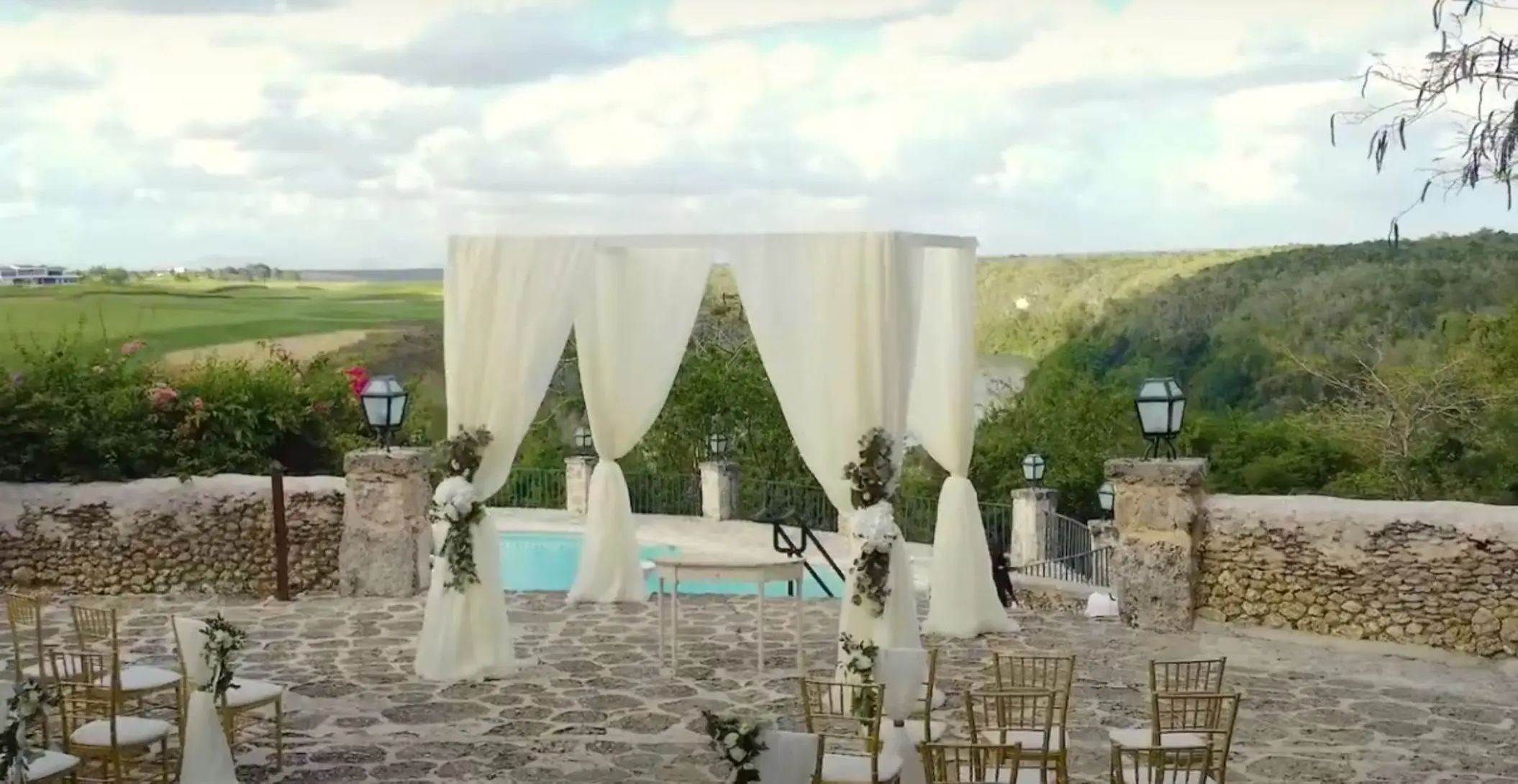 Stone terrace wedding ceremony with white draped gazebo at Casa de Campo, La Romana