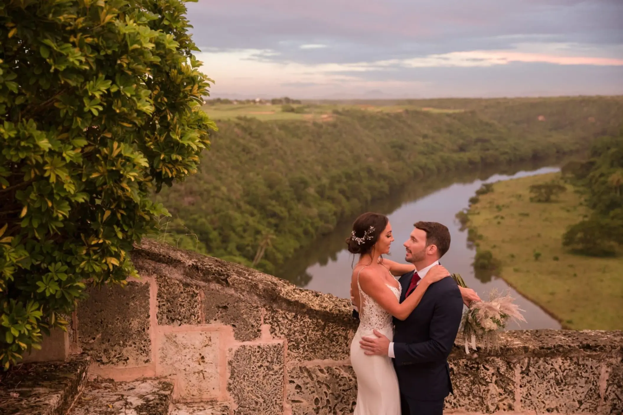Bride and groom portrait overlooking the river at Casa de Campo, La Romana