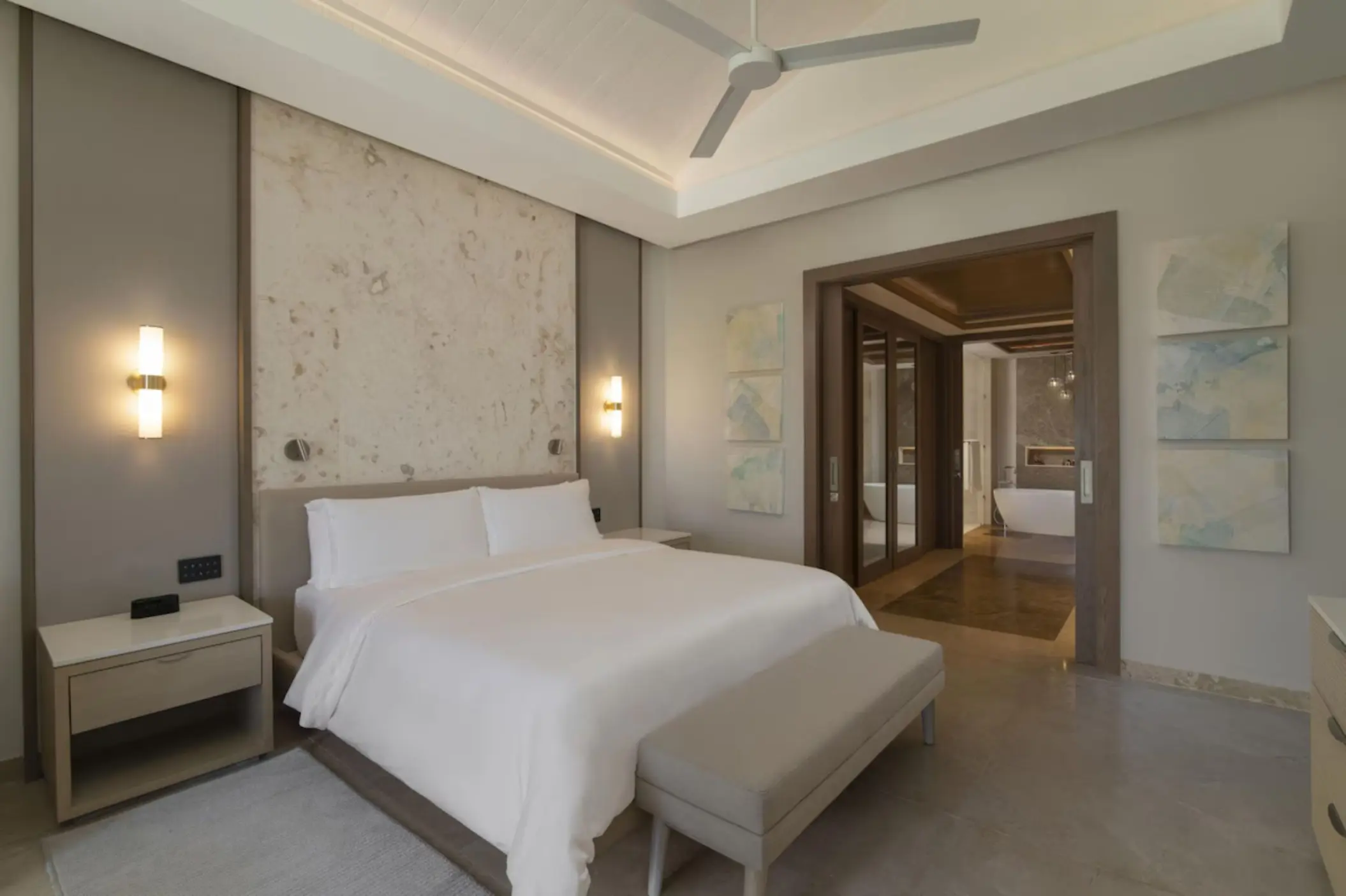 Two-bedroom suite with modern neutral decor and white linens at Casa de Campo, La Romana