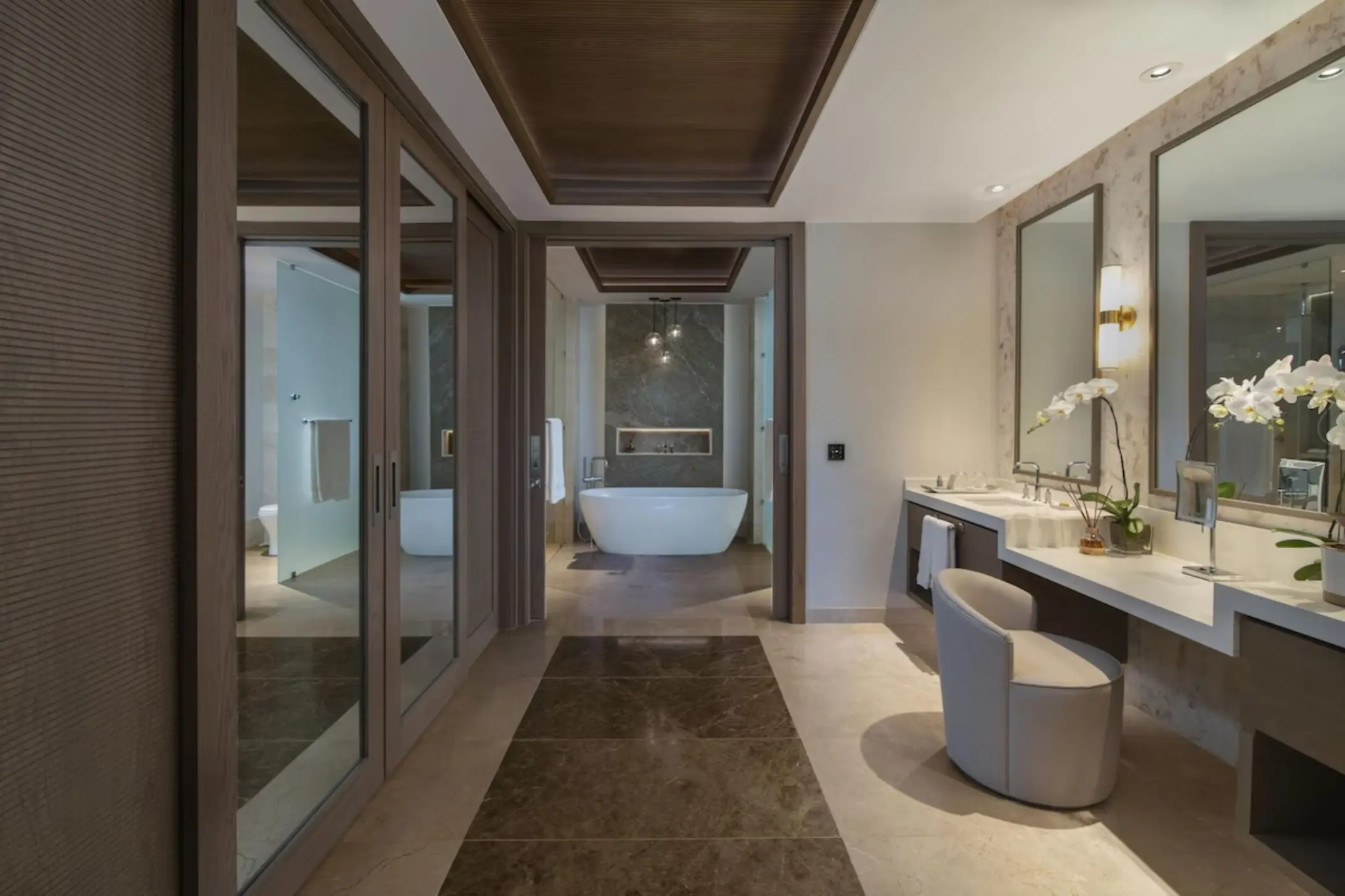 Suite bathroom with a vanity, vanity chair, and soaking tub at Casa de Campo, La Romana